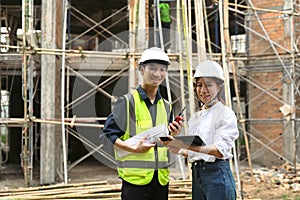 Female architects and engineer standing with arms crossed at construction site. Industry, Engineer, construction concept