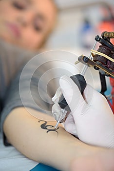 female arm being tatooed
