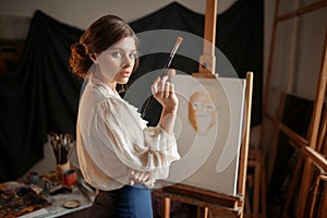 Female artist with color palette and brush