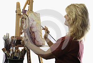 Female artist in her fifties painting