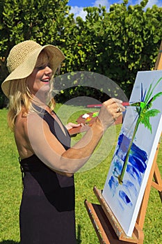 Female artist in her fifties painting