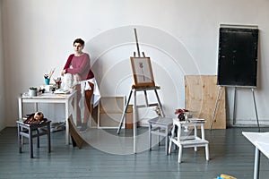 Female artist in her spacious white studio