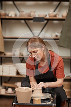 Female Artist Making Ceramics on Pottery Wheel