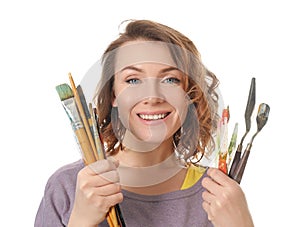 Female artist with paint tools on white background