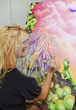 Female artist painting with oil on canvas