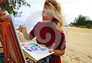 Female artist painting outdoors