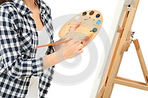 Female artist painting picture on white background