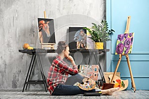 Female artist painting picture in workshop