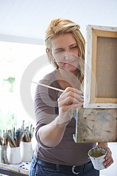 Female Artist Painting In Studio