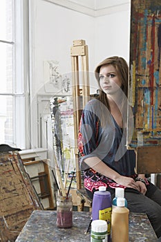 Female artist Sitting In Art Studio