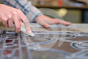 Female artist working with glass