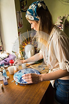 Female artist works on abstract fluid art painting with marble effect