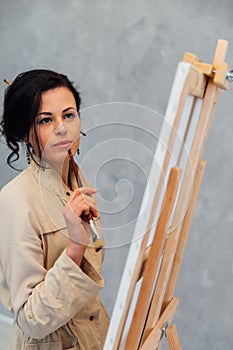 Female Artist Works on Abstract Oil Painting, Moving Paint Brush Energetically She Creates Modern Masterpiece.