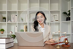 A female Asian lawyer reviews business and real estate laws. Legal consultants provide legal advice and guidance