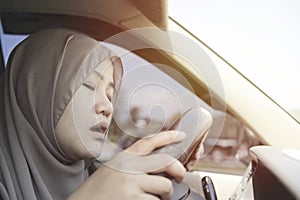 Female Asian muslim driver sleeping while driving a car, dangerous traffic safety accident crash car insurance