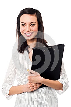 Female assistant holding business files