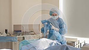 Female assistant near table with laparoscopy equipment in operation room. laparoscopic surgery concept.