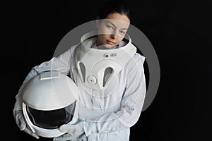 Female astronaut on a black background. Fantastic space suit. Exploration of outer space.