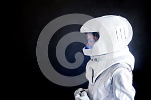 Female astronaut looking left on something. Fantastic space suit. Exploration of outer space.