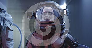 Female astronaut standing in corridor