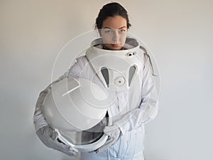 Female astronaut on a white background. Fantastic space suit. Exploration of outer space.