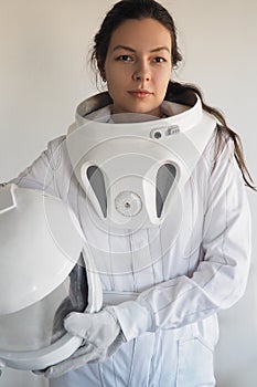 Female astronaut on a white background. Fantastic space suit. Exploration of outer space.