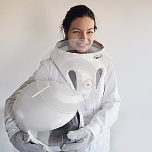 Female astronaut on a white background. Fantastic space suit. Exploration of outer space.