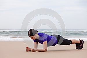 Female athlete executing the plank exercise