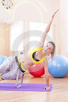 Female Athlete In Good Fit Doing Leg and Hands Stretching Exercises