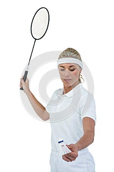 Female athlete holding a badminton racquet ready to serve