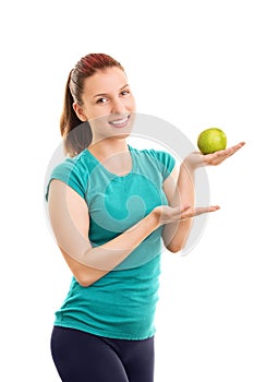 Female athlete holding a green apple