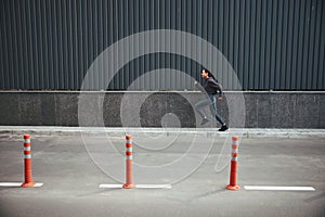 Female athlete jogging along the city street in the morning