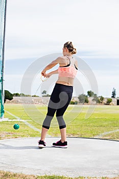 Female athlete performing a hammer throw