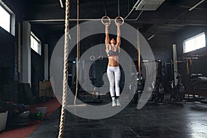 Female Athlete Performing Pull-ups on Gymnastic Rings