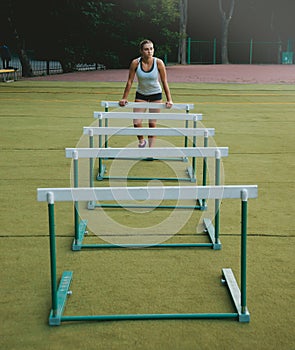 Female athlete in position ready to run.