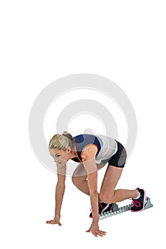 Female athlete in position ready to run