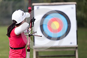 Female athlete practicing archery in stadium