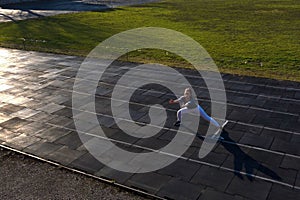 Female athlete preparing legs for cardio workout. Fitness runner doing warm-up routine. woman runner warm up outdoor. athlete