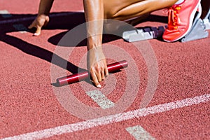 Female athlete ready to start the relay race