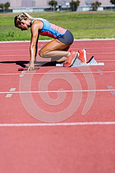 Female athlete ready to start the relay race