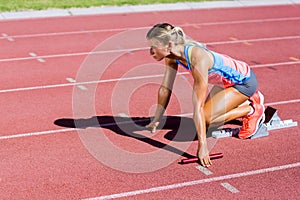 Female athlete ready to start the relay race