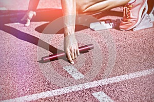 Female athlete ready to start relay race