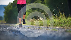 Female athlete runner. closeup on shoe. woman fitness sunset jog