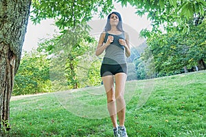 Female athlete/runner running on park: jog workout wFemale athlete/runner running on park - jog workout well-being