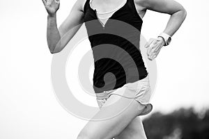 Female athlete running around a beach area in the morning