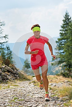 Female athlete running on mountain trail