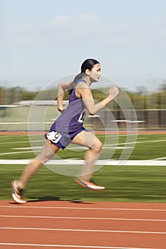 Female Athlete Running On Track