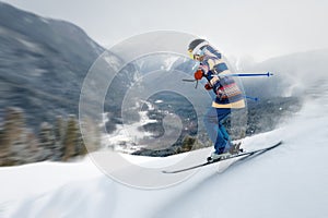 A female athlete skier rides a freeride in a winter forest in the mountains. Jump against the backdrop of snow-covered