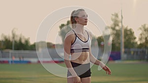 Female athlete starting her sprint on a running track. Runner taking off from the starting blocks on running track