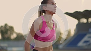 Female athlete starting her sprint on a running track. Runner taking off from the starting blocks on running track